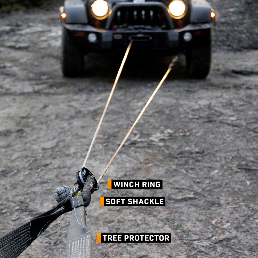 Winch rope running through a snatch ring during a recovery