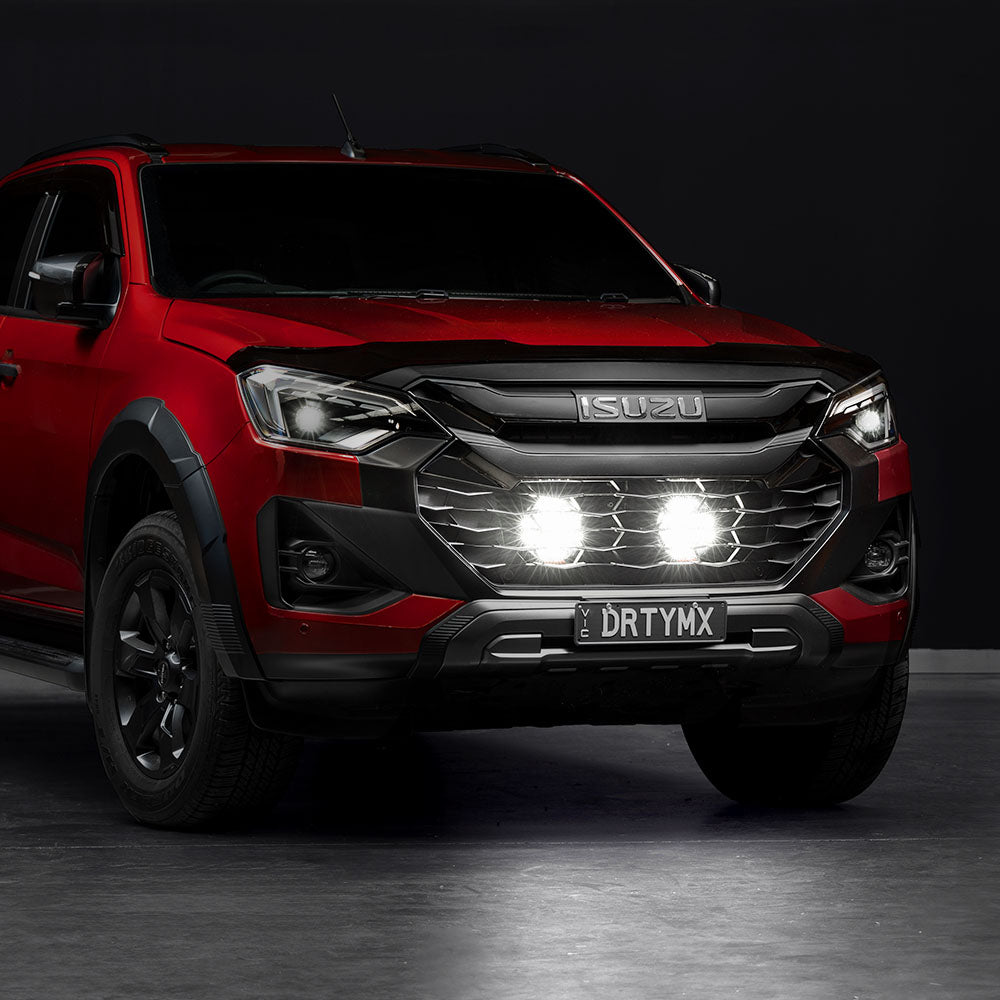 Altiq LED spot lights switched on behind the grille of an Isuzu D-Max