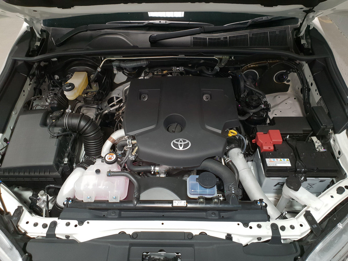 Engine bay of an N80 Toyota Hilux with an HPD intercooler kit fitted